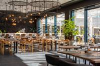 a restaurant with tables and chairs and windows at Barceló Playa Blanca in Playa Blanca