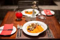 Una mesa de madera con un plato de comida encima. en abba Presidente Suites Santiago, en Santiago