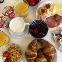 a table with a bunch of breakfast foods and drinks at Hotel Genova Liberty in Genoa