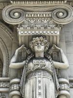a statue of a woman on the side of a building at Hotel Genova Liberty in Genoa