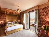 a bedroom with a large bed and a balcony at Hotel Papadopoli Venezia - MGallery Collection in Venice