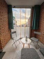 a room with two chairs and a table and a window at Mega Lux Apartment in Vračar (historical)
