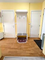 a room with two doors and a bench on a rug at Mega Lux Apartment in Vračar (historical)