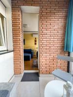 a brick wall divides the living room from the dining room at Mega Lux Apartment in Vračar (historical)