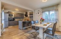 a kitchen and dining room with a table and chairs at Beautiful Home In Skatari With Outdoor Swimming Pool in Škatari