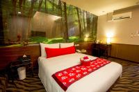 a bedroom with a large bed with red pillows at Hotel 6 - Wannien in Taipei