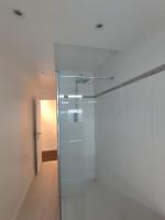 a glass shower door in a bathroom with a hallway at Logement entier : appartement - Brest in Brest