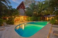 a swimming pool in front of a house at Living Hotel in Nosara