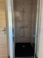 a shower with a glass door in a bathroom at Le Sailhet, maison de vacances in Pierrefitte-Nestalas