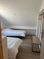 a bedroom with two bunk beds and a table at Le Sailhet, maison de vacances in Pierrefitte-Nestalas