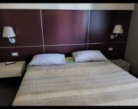 A bed or beds in a room at Uniclub House