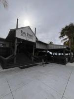 a building with a sign that reads dog foodrint at Oceanfront Luxury Condo! Mins to beach! Rum Bar Next Door! in St Petersburg