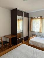 a bedroom with two beds and a table and a desk at VILLA M Slatina Banja Luka 