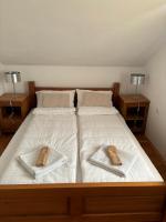 a large bed with two towels on top of it at VILLA M Slatina Banja Luka 