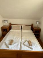 a large bed with two towels on top of it at VILLA M Slatina Banja Luka 