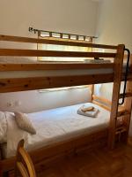 a bedroom with two bunk beds and a chair at VILLA M Slatina Banja Luka 
