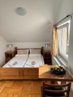 a bedroom with a bed and a wooden table at VILLA M Slatina Banja Luka 