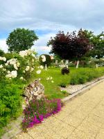 a garden with pink and white flowers and trees at Appartement de 3 chambres avec jardin clos et wifi a Toulonjac in Toulonjac
