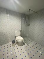 a bathroom with a toilet and a glass shower at Samui Green Hotel in Chaweng