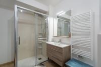 a bathroom with a glass shower and a sink at CHARMANT APPARTEMENT CENTRE VILLE in Arcachon