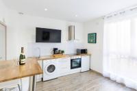 a white kitchen with a washer and dryer at Tranquilis - Studio hypercentre terrasse parking in Reims