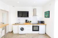 a kitchen with a sink and a washing machine at Tranquilis - Studio hypercentre terrasse parking in Reims