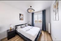 a bedroom with a large bed and a window at Disney best location &amp; confortable 4 beds - All by feet in Serris