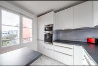 a kitchen with white cabinets and a large window at Disney best location &amp; confortable 4 beds - All by feet in Serris