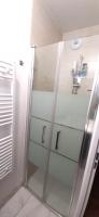 a glass cabinet with glass shelves in a bathroom at Disney best location &amp; confortable 4 beds - All by feet in Serris