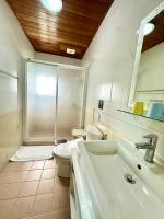 a bathroom with a shower and a sink and a toilet at Li Wu Zuo Cun B&amp;B in Chongde