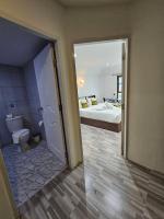 a bathroom with a bedroom with a bed and a toilet at Samui Green Hotel in Chaweng