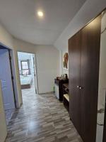 a room with a hallway with a wooden cabinet and a bedroom at Samui Green Hotel in Chaweng