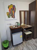 a room with a desk with a painting of an elephant at Samui Green Hotel in Chaweng