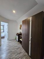 a room with a large wooden cabinet and a bathroom at Samui Green Hotel in Chaweng