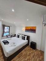 a bedroom with a large bed and a table at Samui Green Hotel in Chaweng