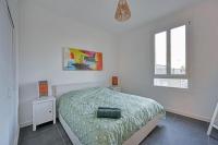 a white bedroom with a bed and two windows at The Rooftop - AC CLIM - Wi-Fi - Parking gratuit dans la rue in Avignon