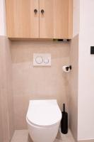 a bathroom with a white toilet and wooden cabinets at *Cozy flat-Latin Quarter in the heart of Paris* in Paris