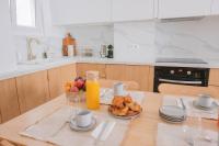 a kitchen with a table with a plate of food and orange juice at *Cozy flat-Latin Quarter in the heart of Paris* in Paris