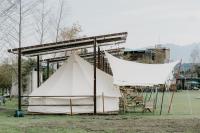 a large white tent in a field with chairs at The Silence Manor in Ruisui