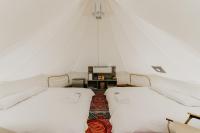 two beds in a room with a tent at The Silence Manor in Ruisui