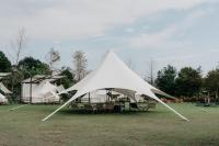 a large white tent sitting in a field at The Silence Manor in Ruisui