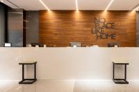 a white counter with a no place like home sign on a wall at Home Hotel in Taipei