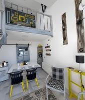 a room with a table and chairs and a train on the wall at okeyloft Coyhaique 1 in Coihaique
