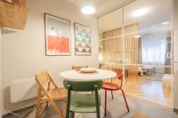 a dining room and living room with a table and chairs at GREENKO Apartment in Zagreb