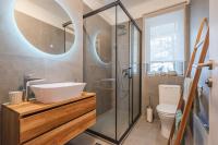 a bathroom with a sink and a shower and a toilet at GREENKO Apartment in Zagreb
