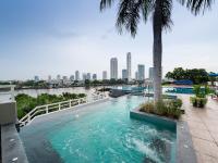 a swimming pool with a view of a city skyline at Chatrium Hotel Riverside Bangkok in Bangkok