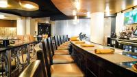 a bar with a row of seats at a restaurant at Holiday Inn Washington Capitol-National Mall by IHG in Washington