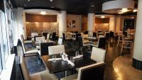 a dining room with tables and chairs in a restaurant at Holiday Inn Washington Capitol-National Mall by IHG in Washington
