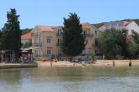 a group of people on a beach near the water at Apartments by the sea Kraj, Pasman - 3460 in Pašman