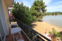 a balcony with a view of a beach and water at Apartments by the sea Kraj, Pasman - 3460 in Pašman
